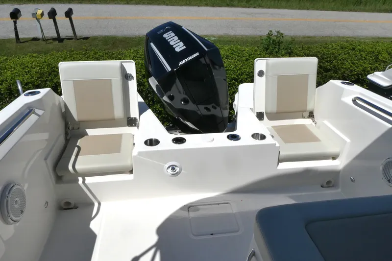 Slide: The Image of 2025 Boston Whaler 210 Vantage boat interior with seating and Mercury outboard motor. - 10
