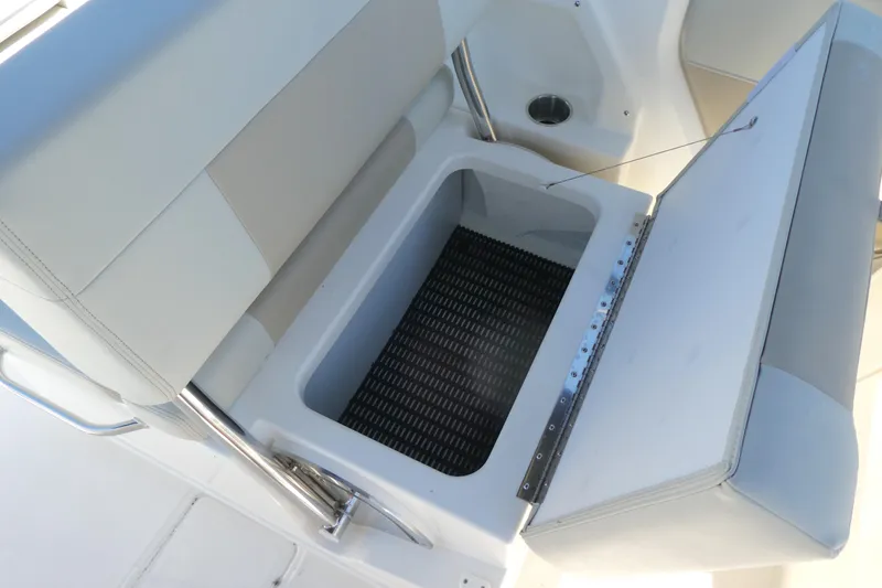 Slide: The Image of 2025 Boston Whaler 210 Vantage boat seat with open storage compartment. - 4