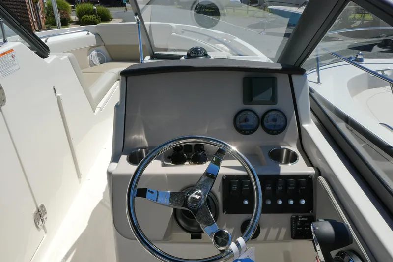 Slide: The Image of 2025 Boston Whaler 210 Vantage boat dashboard with steering wheel and gauges. - 7