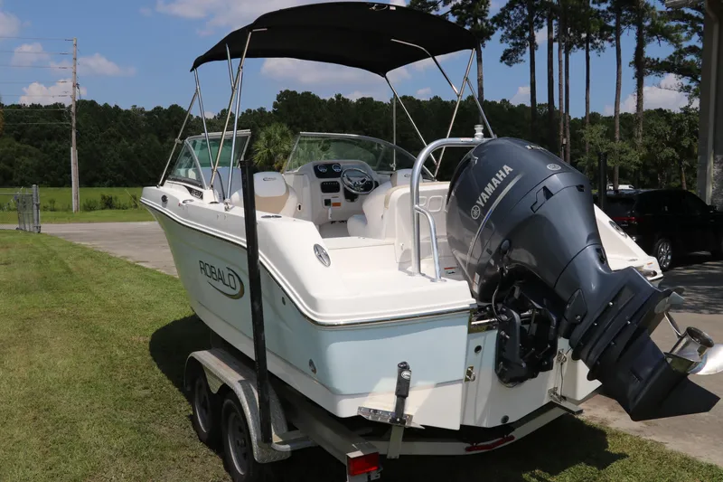 Slide: The Image of 2019 Robalo R207 Dual Console boat with Yamaha engine on trailer, parked outdoors. - 1