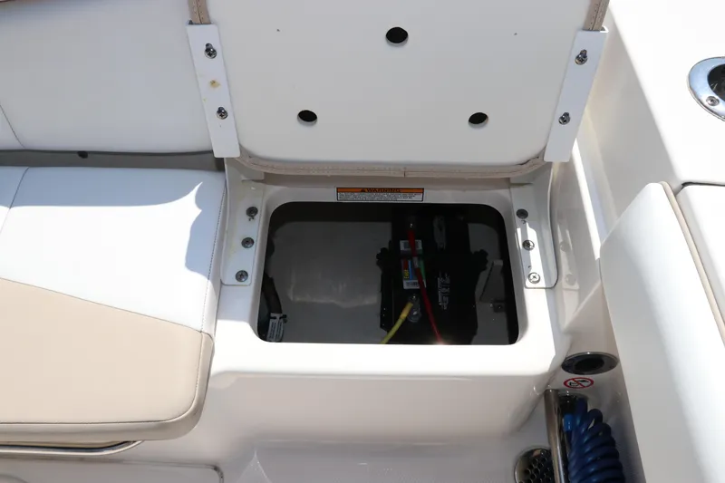 Slide: The Image of 2019 Robalo R207 Dual Console boat battery compartment with open hatch. - 11