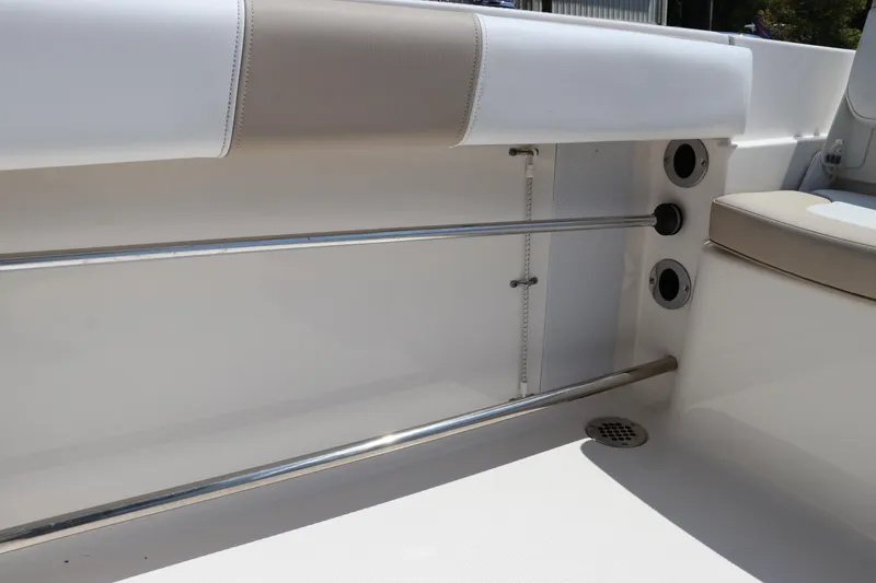Slide: The Image of 2019 Robalo R207 Dual Console interior with stainless steel rails and cushioned seating. - 13