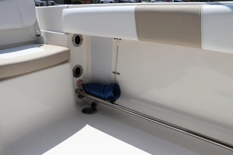 Slide: The Image of 2019 Robalo R207 Dual Console interior with seating and storage area. - 14