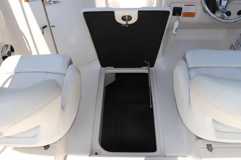 Slide: The Image of 2019 Robalo R207 Dual Console boat interior with open storage compartment. - 19
