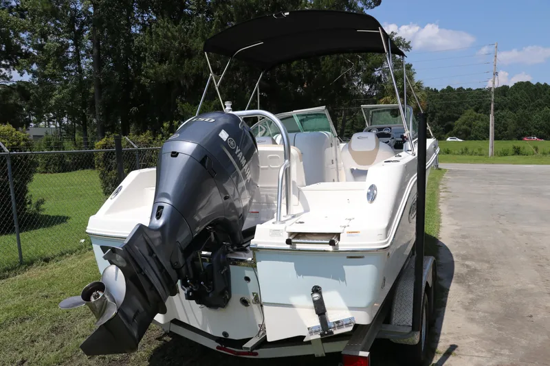 Slide: The Image of 2019 Robalo R207 Dual Console boat with Yamaha outboard engine on a trailer. - 2