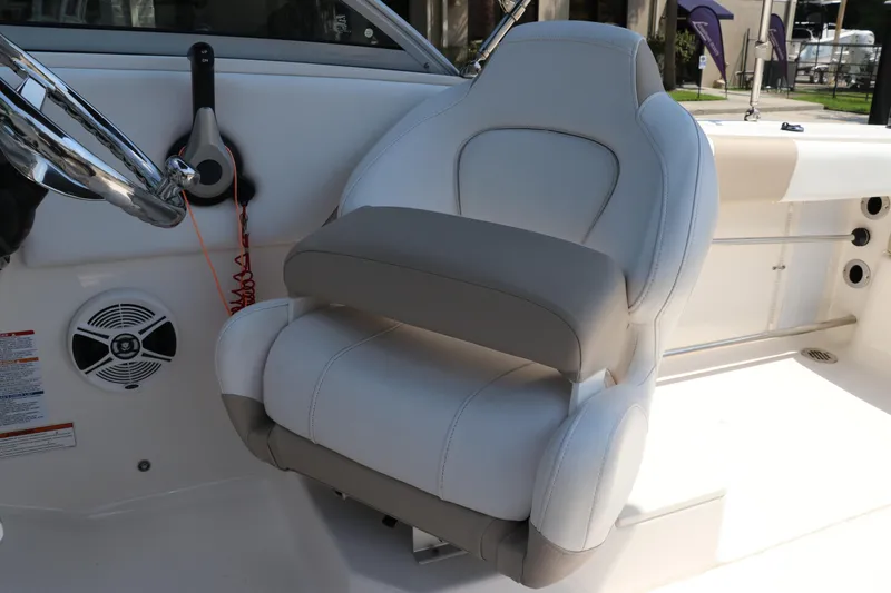 Slide: The Image of 2019 Robalo R207 Dual Console boat interior with steering wheel and cushioned seat. - 25