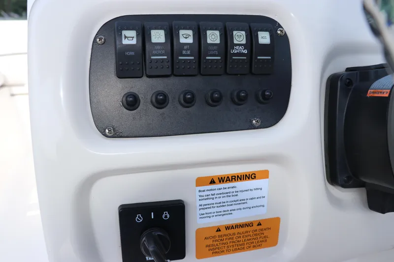Slide: The Image of Control panel of 2019 Robalo R207 Dual Console boat with warning labels. - 31
