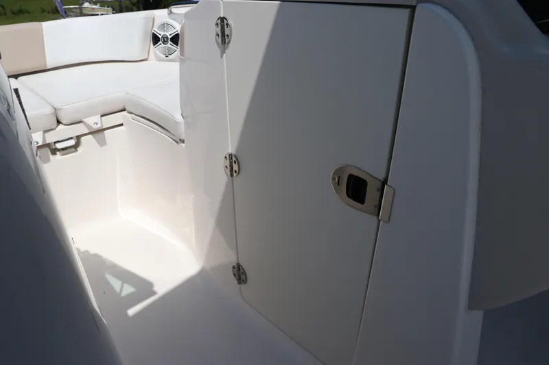 Slide: The Image of 2019 Robalo R207 Dual Console boat interior with seating and storage compartment. - 34