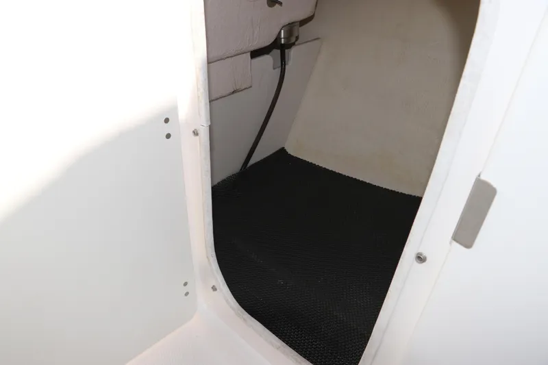 Slide: The Image of 2019 Robalo R207 Dual Console interior storage compartment with black flooring. - 35