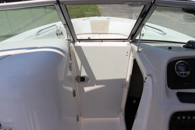 Slide: The Image of 2019 Robalo R207 Dual Console boat interior with dashboard and open compartment. - 36