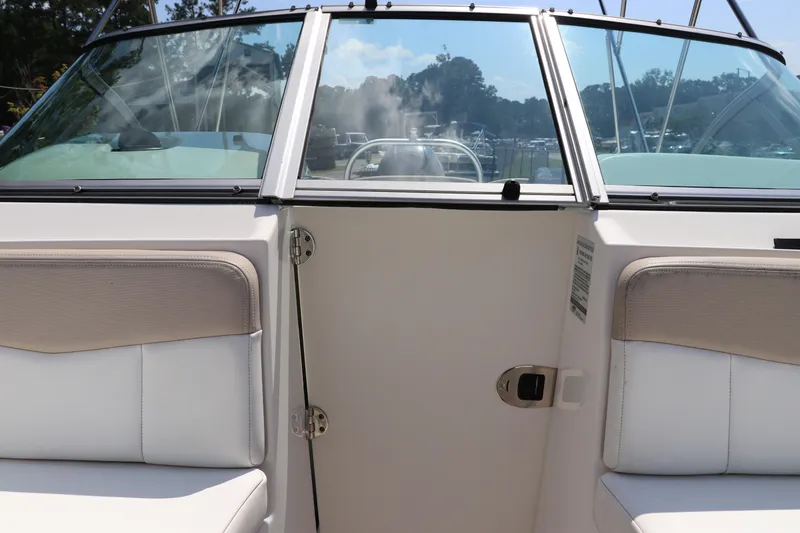 Slide: The Image of 2019 Robalo R207 Dual Console boat interior with seating and windshield view. - 37