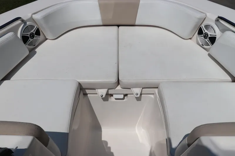 Slide: The Image of 2019 Robalo R207 Dual Console boat interior with white cushioned seating and speakers. - 38