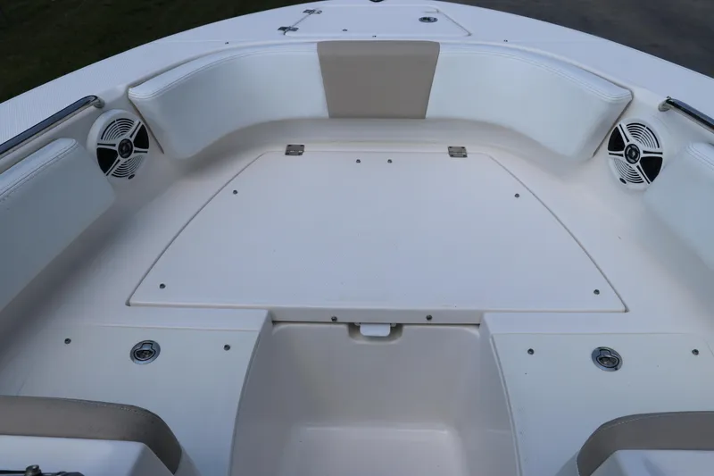 Slide: The Image of 2019 Robalo R207 Dual Console boat interior with white seating and speakers. - 39