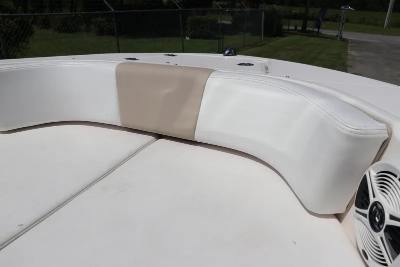 Slide: The Image of 2019 Robalo R207 Dual Console boat interior with cushioned seating and speaker. - 40