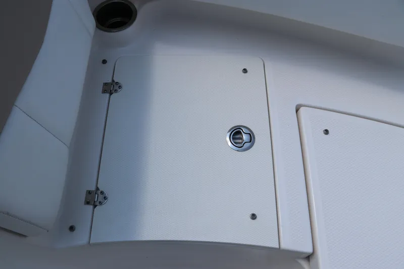 Slide: The Image of 2019 Robalo R207 Dual Console boat storage compartment with secure latch and hinges. - 43