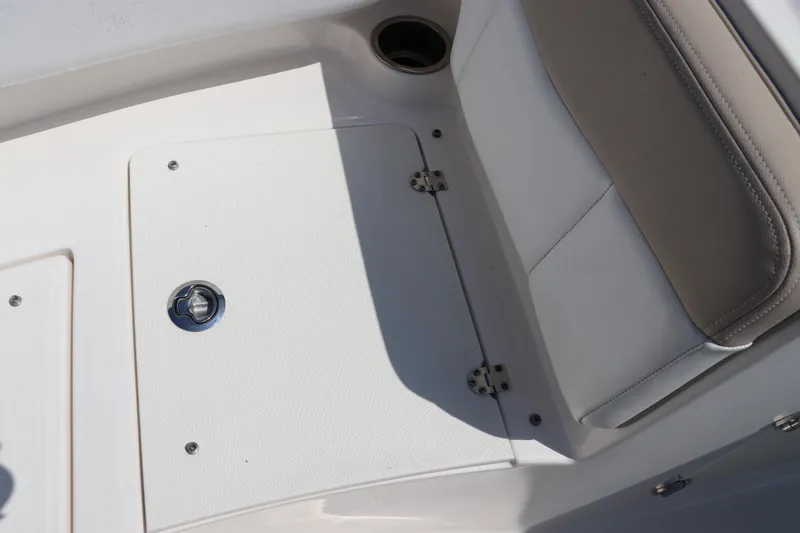 Slide: The Image of 2019 Robalo R207 Dual Console boat interior with storage compartment and seating. - 47