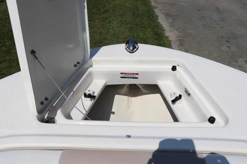 Slide: The Image of Open storage compartment on 2019 Robalo R207 Dual Console boat. - 50