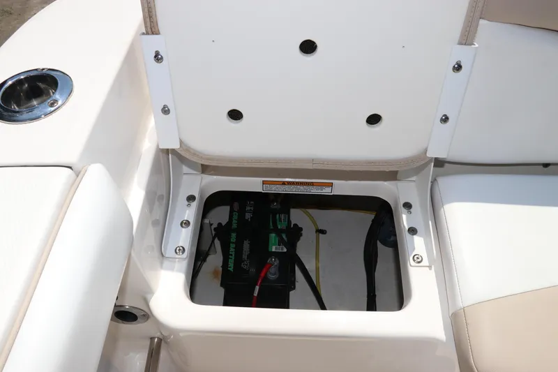 Slide: The Image of 2019 Robalo R207 Dual Console boat battery compartment with open seat storage. - 7