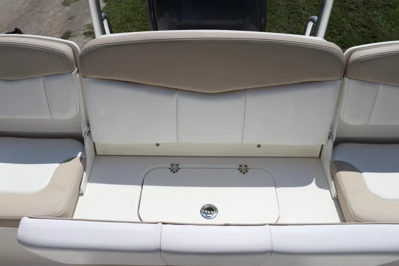 Slide: The Image of 2019 Robalo R207 Dual Console boat seating area with beige and white upholstery. - 9