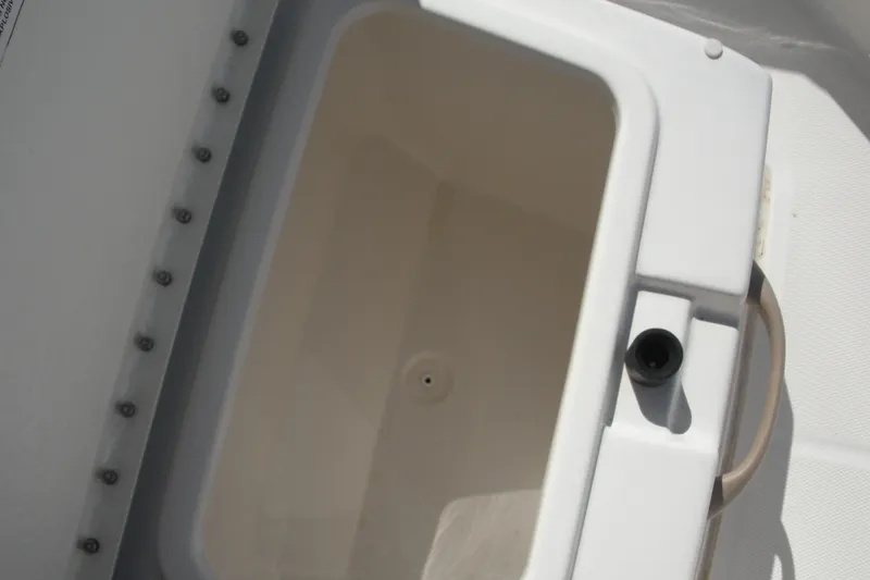 Slide: The Image of 2025 Bayliner Trophy T20CC boat storage compartment, open and empty. - 10