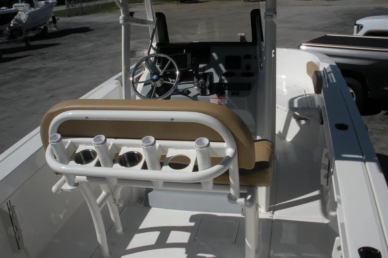 Slide: The Image of 2025 Bayliner Trophy T20CC boat interior with steering wheel and rod holders. - 11