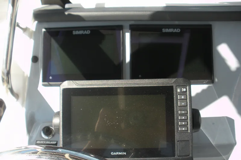 Slide: The Image of 2025 Bayliner Trophy T20CC dashboard with Simrad and Garmin displays. - 12