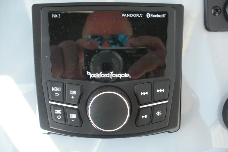 Slide: The Image of Rockford Fosgate PMX-2 audio system on 2025 Bayliner Trophy T20CC boat dashboard. - 13