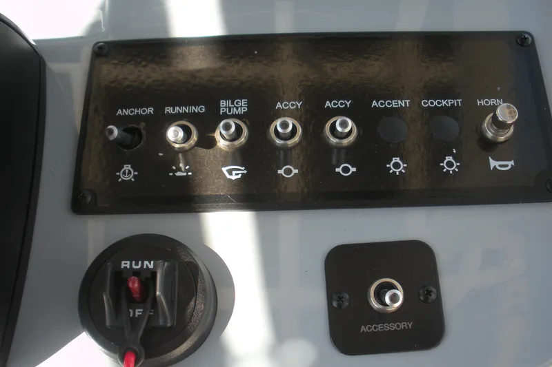 Slide: The Image of Control panel of 2025 Bayliner Trophy T20CC boat with various switches and buttons. - 14