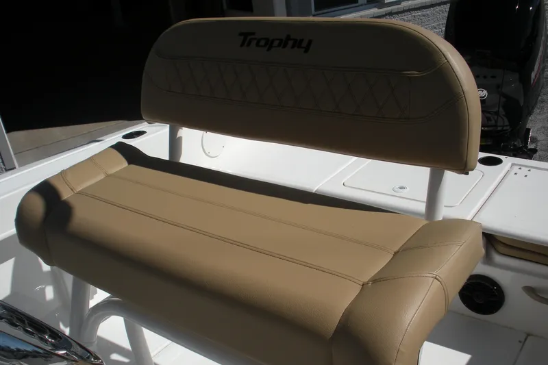 Slide: The Image of 2025 Bayliner Trophy T20CC boat seat with tan upholstery and "Trophy" logo. - 15