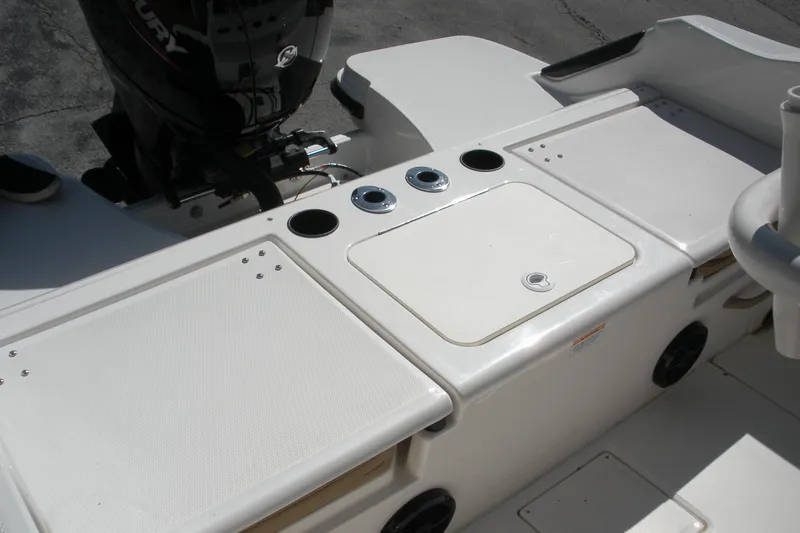 Slide: The Image of 2025 Bayliner Trophy T20CC boat deck with storage compartments and Mercury engine. - 16