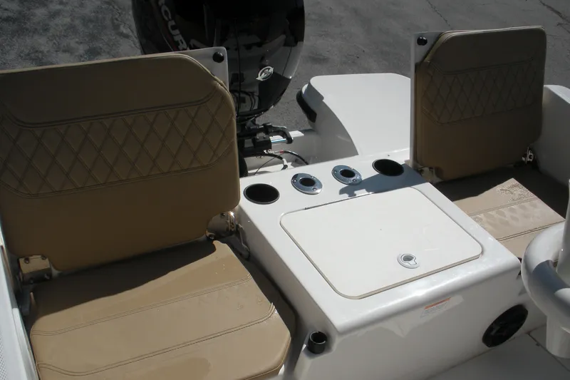 Slide: The Image of 2025 Bayliner Trophy T20CC boat seating and storage area with beige cushions. - 17
