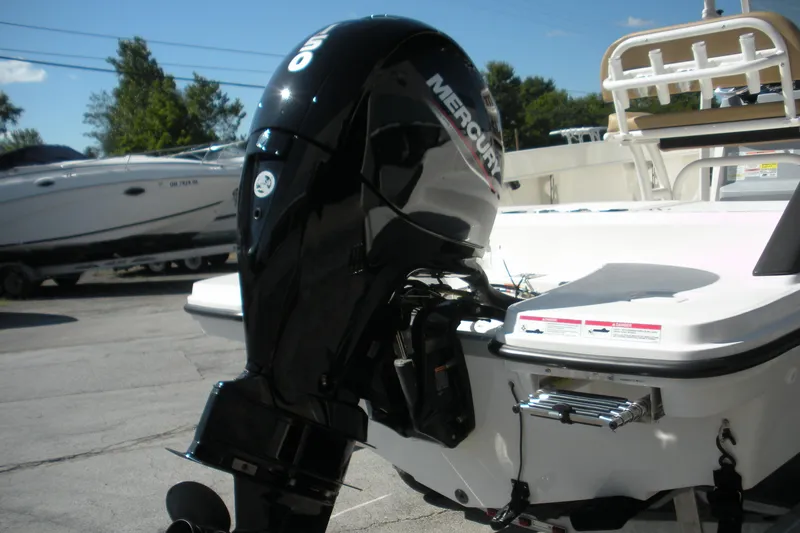 Slide: The Image of 2025 Bayliner Trophy T20CC with Mercury outboard motor, parked outdoors. - 19
