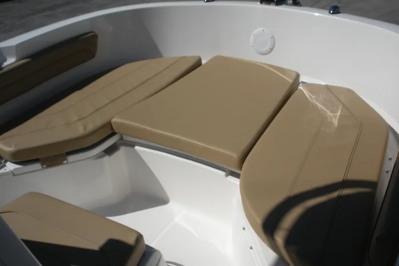 Slide: The Image of 2025 Bayliner Trophy T20CC boat with tan cushioned seating in the bow area. - 7