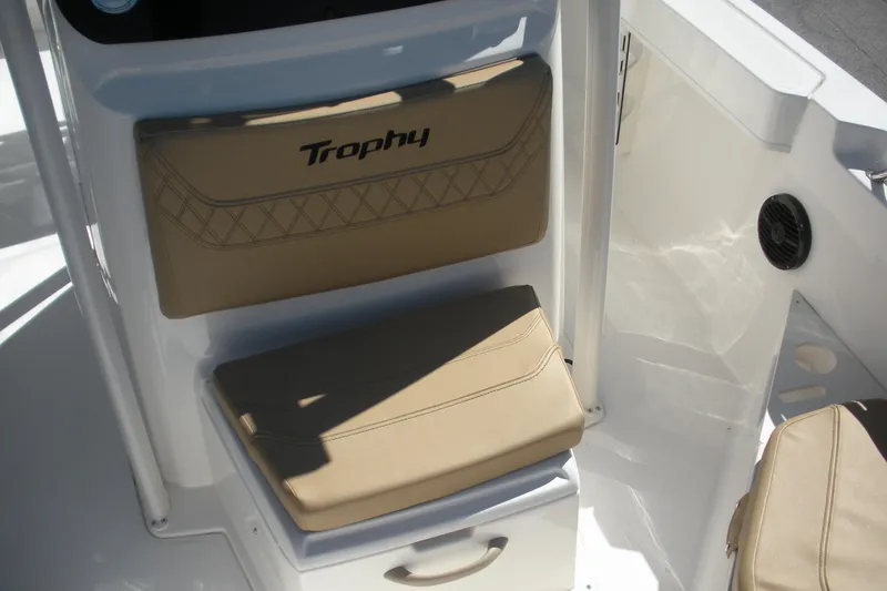 Slide: The Image of 2025 Bayliner Trophy T20CC boat interior with tan seating and console. - 8