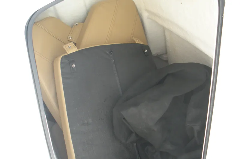 Slide: The Image of 2025 Bayliner Trophy T20CC interior storage with tan seats and black cover. - 9