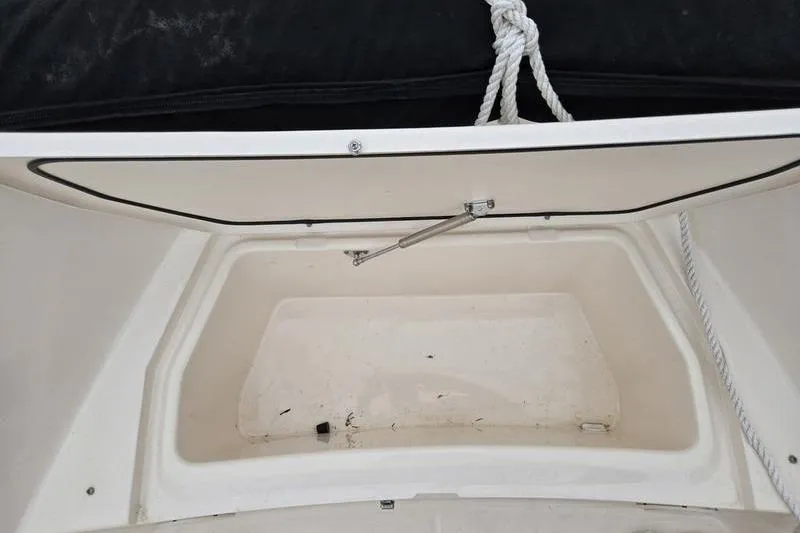 Slide: The Image of Open storage compartment on 2024 Grady-White Fisherman 180 boat, featuring a white interior. - 11
