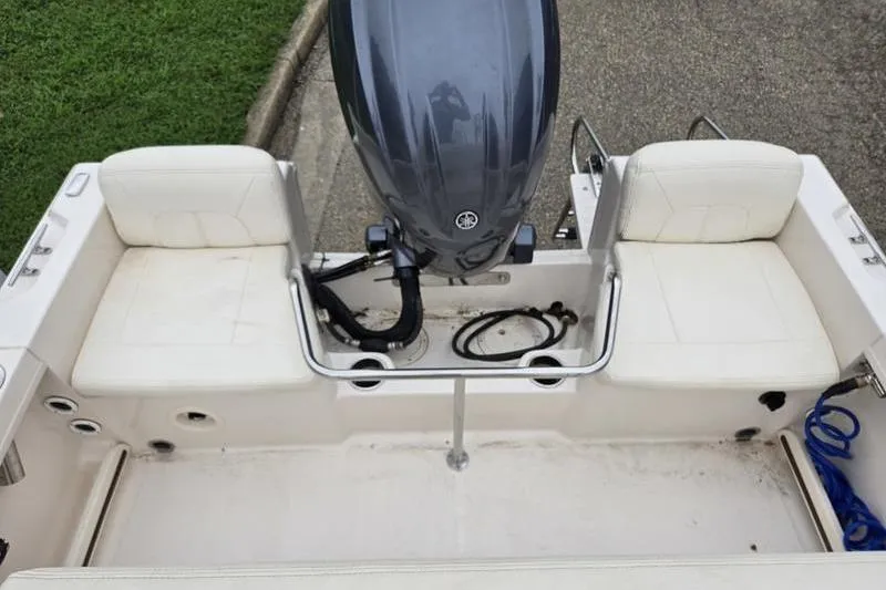 Slide: The Image of 2024 Grady-White Fisherman 180 boat interior with motor and seating. - 7