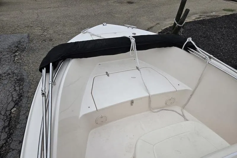 Slide: The Image of 2024 Grady-White Fisherman 180 boat interior with storage compartment and ropes. - 9