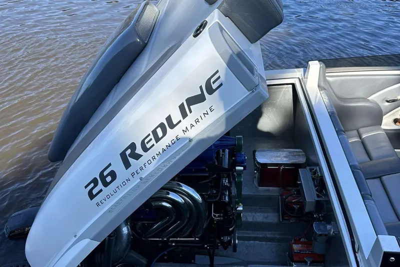 Slide: The Image of RPM REDLINE 2008 boat engine compartment, featuring "26 REDLINE" branding near water. - 10