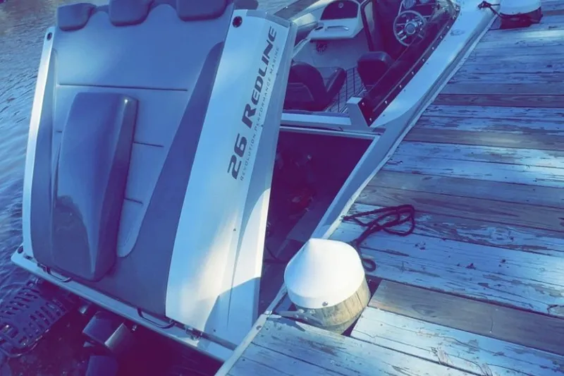 Slide: The Image of 2008 RPM REDLINE boat docked, showcasing sleek design and powerful engine. - 11