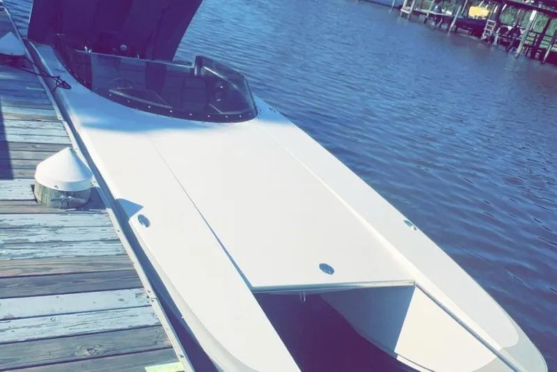 Slide: The Image of 2008 RPM REDLINE boat docked on calm water, showcasing sleek design and open cockpit. - 12