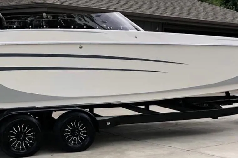 Slide: The Image of 2008 RPM REDLINE boat on trailer, sleek design, parked in driveway. - 6
