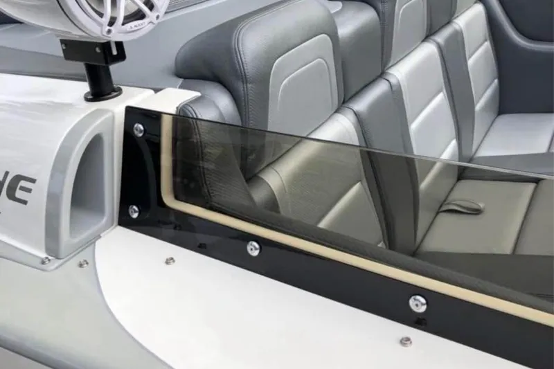 Slide: The Image of 2008 RPM REDLINE boat interior with gray leather seats and speaker system. - 8