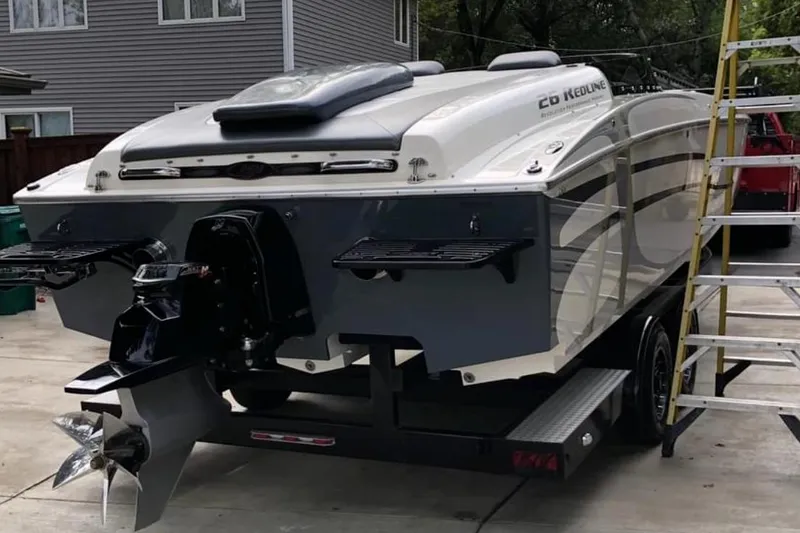 Slide: The Image of 2008 RPM REDLINE boat on trailer, parked in driveway with ladder nearby. - 9