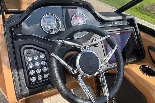 Slide: The Image of Steering console of 2025 Godfrey San Pan SP2700SBW boat with modern controls and dashboard. - 10