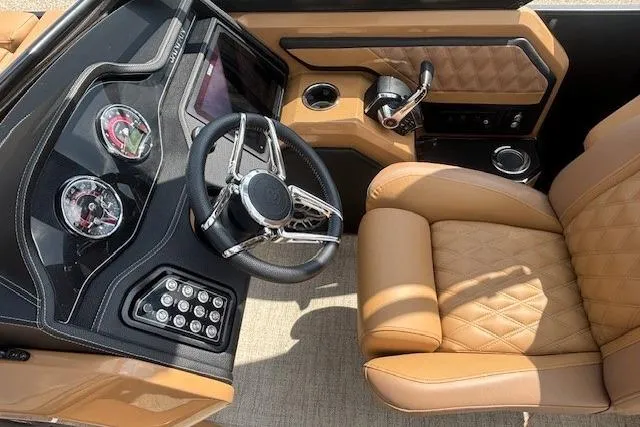 Slide: The Image of Luxurious 2025 Godfrey San Pan SP2700SBW boat interior with tan leather seating and modern dashboard. - 11