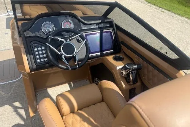 Slide: The Image of Interior of 2025 Godfrey San Pan SP2700SBW boat with modern dashboard and steering wheel. - 12