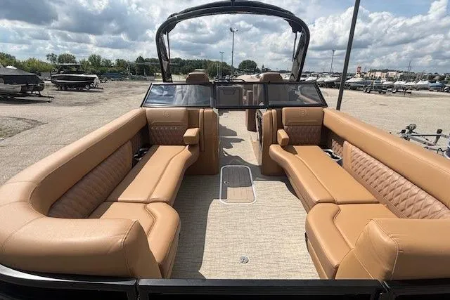 Slide: The Image of Luxurious 2025 Godfrey San Pan SP2700SBW pontoon boat with spacious tan seating. - 14