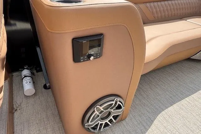 Slide: The Image of Luxury boat interior with tan leather seating, speaker, and control panel, Godfrey San Pan SP2700SBW 2025. - 15