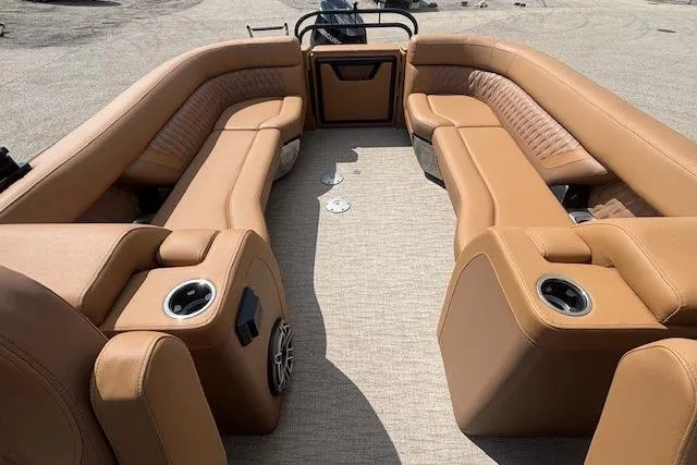 Slide: The Image of Luxurious 2025 Godfrey San Pan SP2700SBW boat interior with tan leather seating and cup holders. - 28
